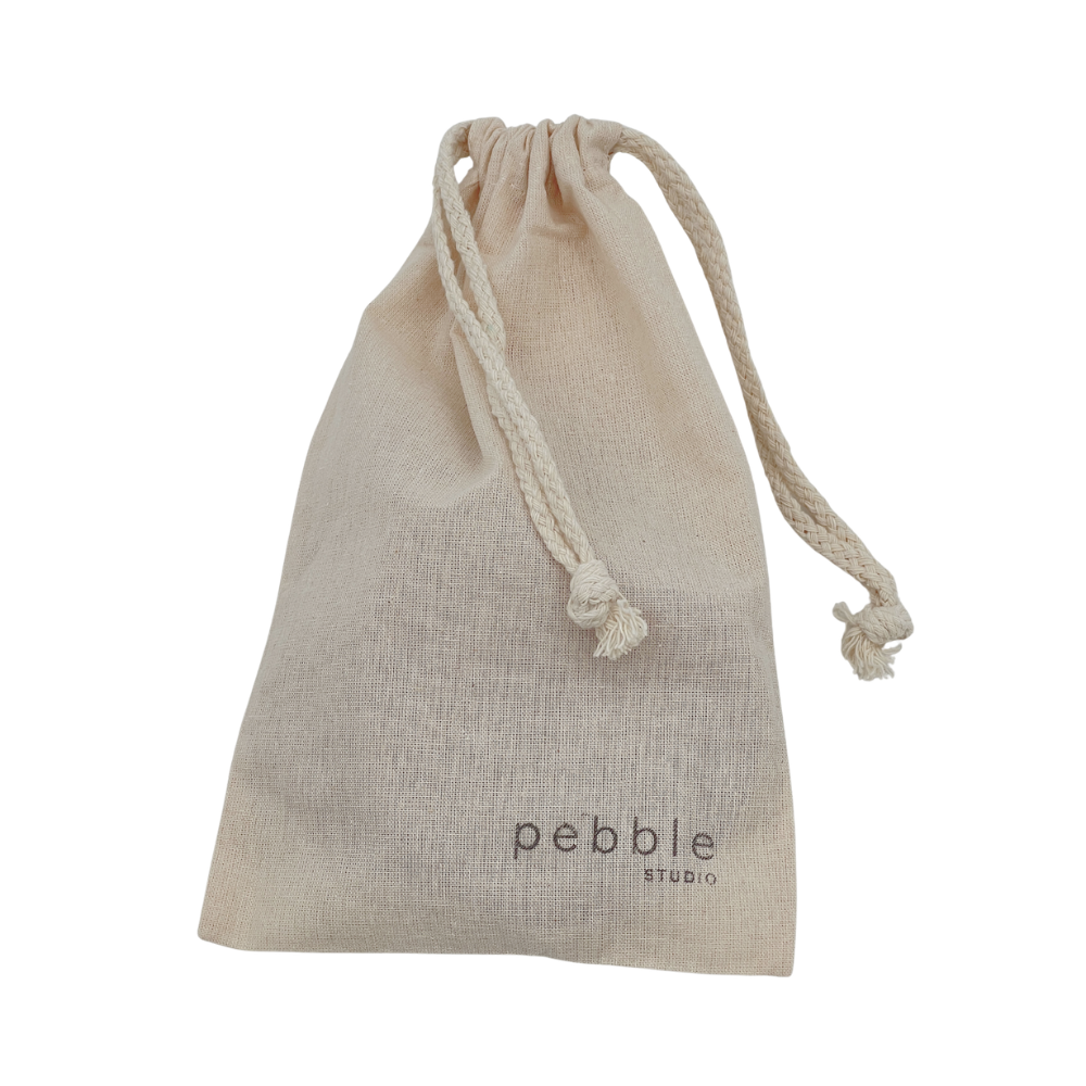 Calico drawstring pouch with 'pebble studio' branding on a white background