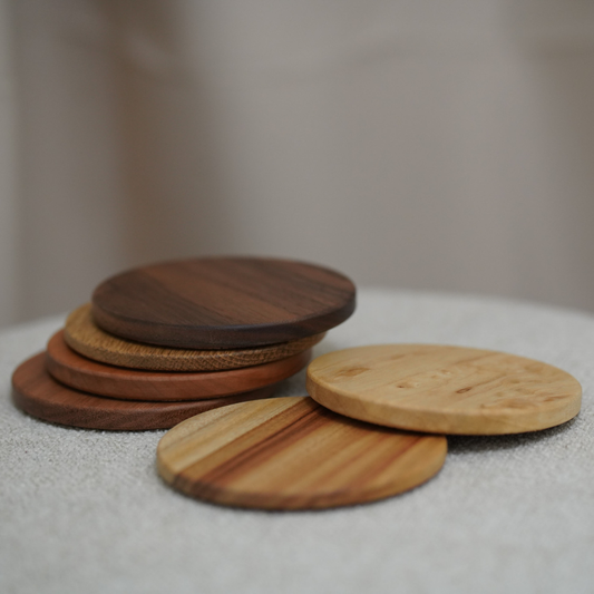 Stack of wooden coasters on a textured surface