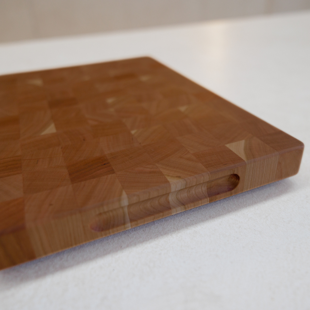 Wooden chopping board on a white surface