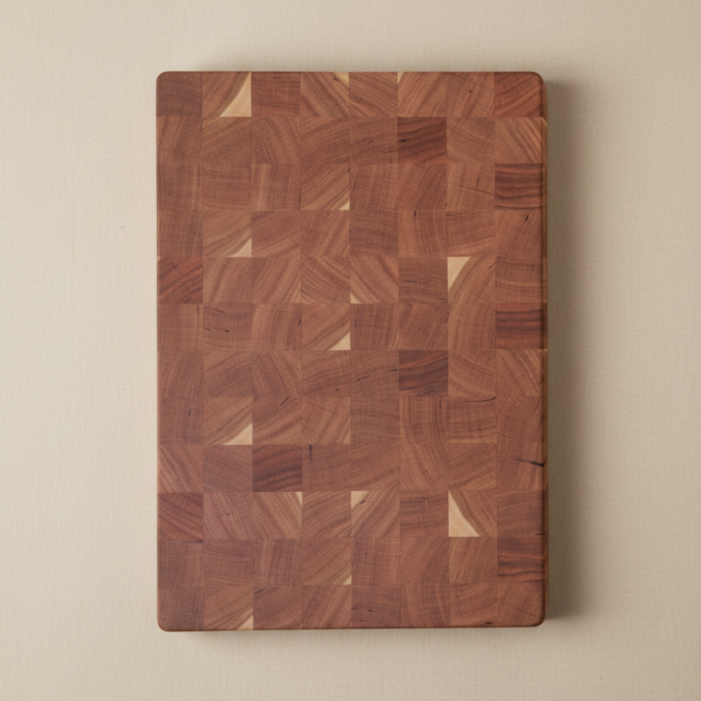 Wooden end-grain chopping board on a beige background