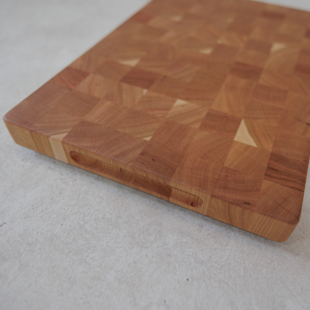 Wooden cutting board on a light grey surface
