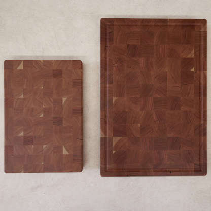 Two wooden chopping boards with a geometric pattern on a light background