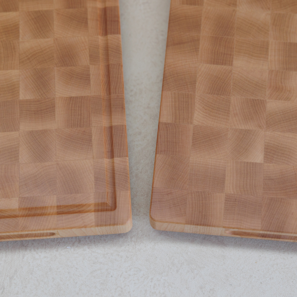 Two wooden cutting boards on a light grey surface