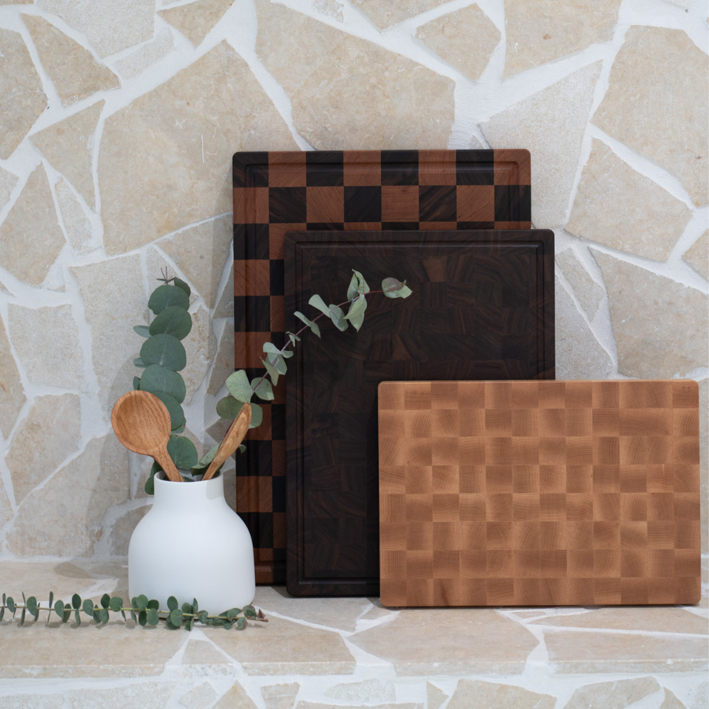 Set of wooden cutting boards with a checkered pattern on a stone surface