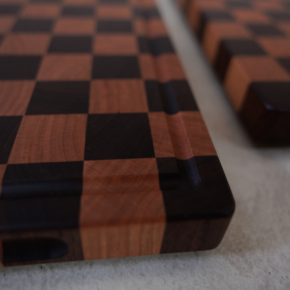 Close-up of a wooden chopping board with checkered pattern