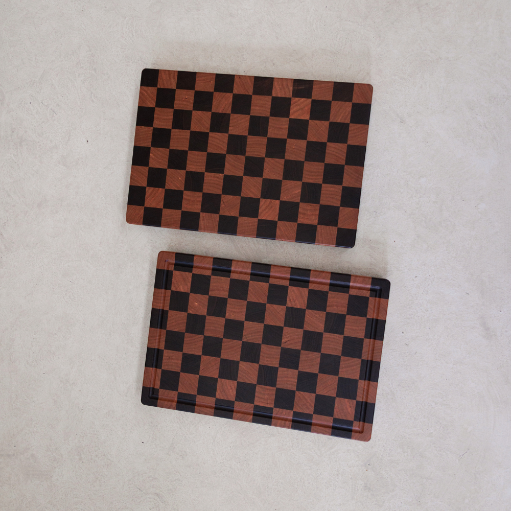 Two checkered rectangular chopping boards on a light grey background