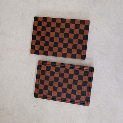 Two checkered rectangular chopping boards on a light grey background