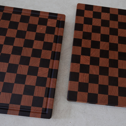 Two checkered chopping boards on a light grey surface