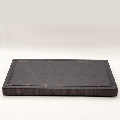 Walnut end-grain chopping board on a white background