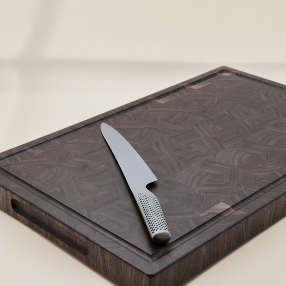 Knife on a wooden end-grain chopping board with a beige background