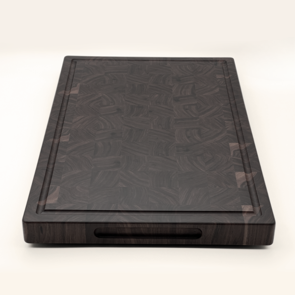 Walnut end-grain chopping board on a white background