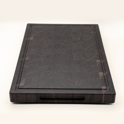 Walnut end-grain chopping board on a white background