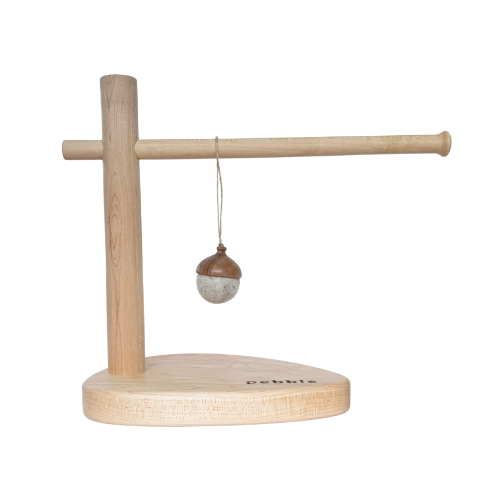 Hand turned walnut and marbled beige felt acorn ornament with jute loop, hanging from a wooden stand. Australian handmade natural Christmas decoration