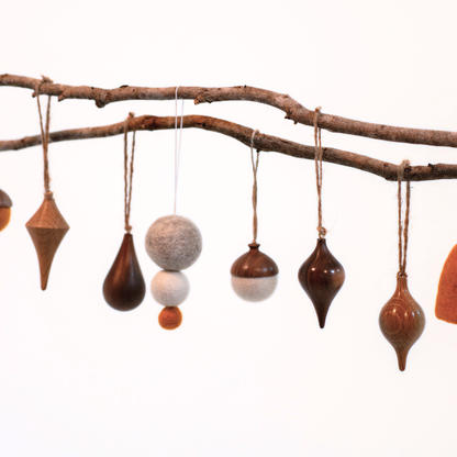 Decorative hanging ornaments on a branch with a white background