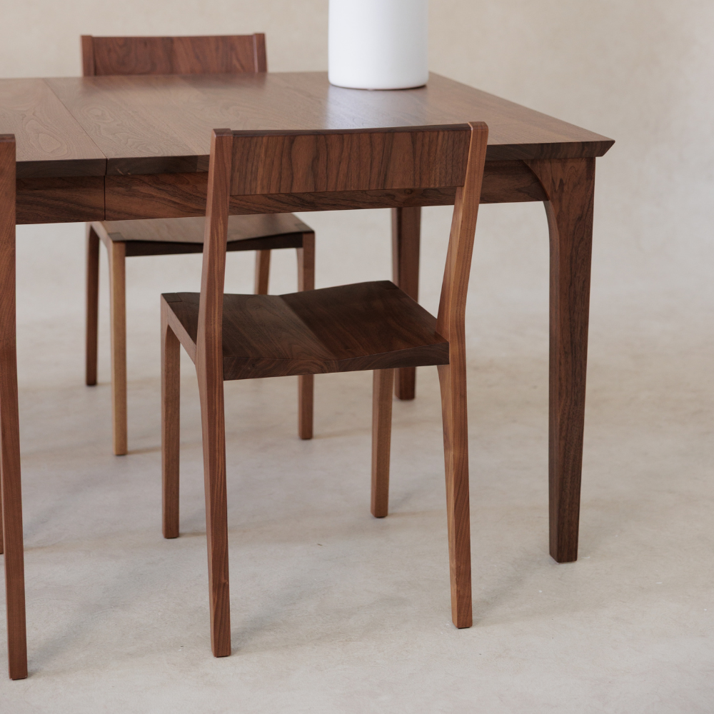 Wooden dining table and chairs on a light background