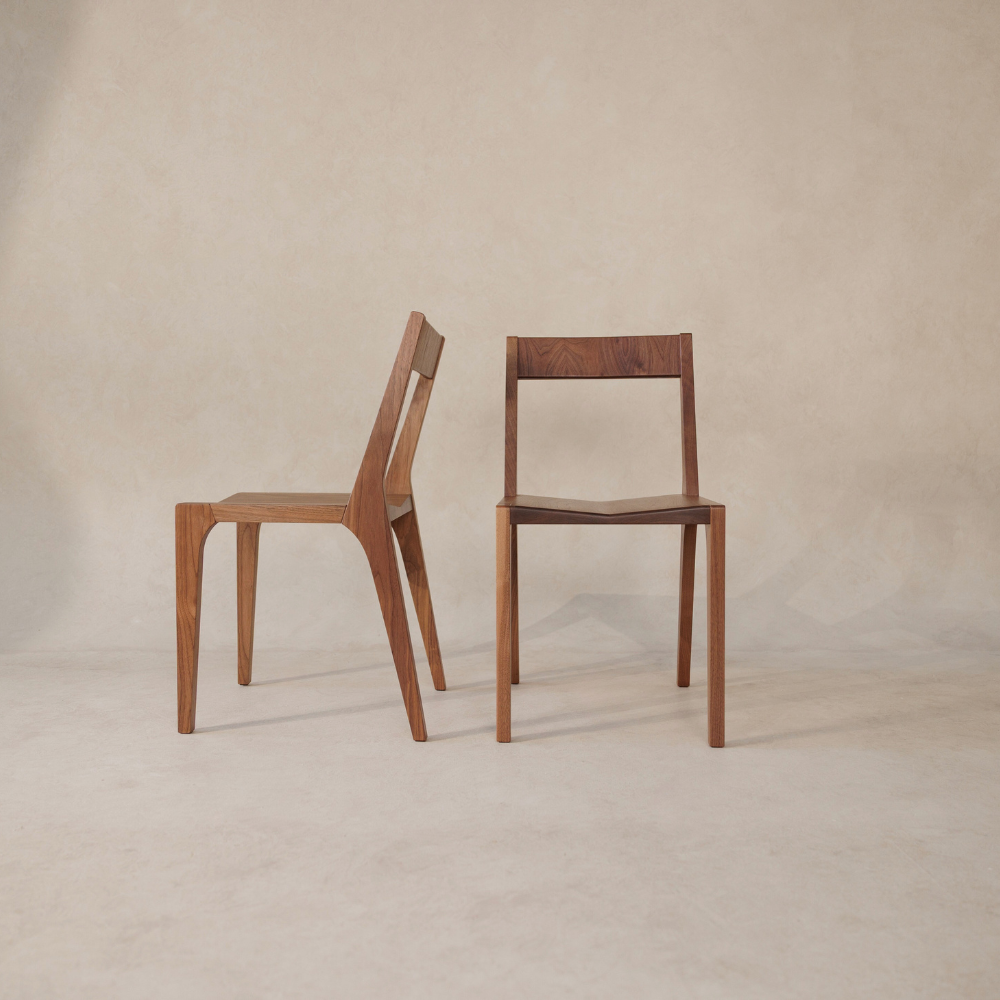 Two wooden chairs on a beige background