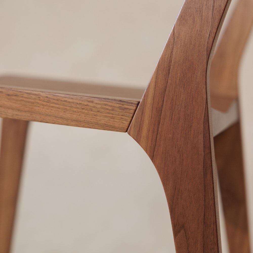 Close-up of a wooden chair with a neutral background