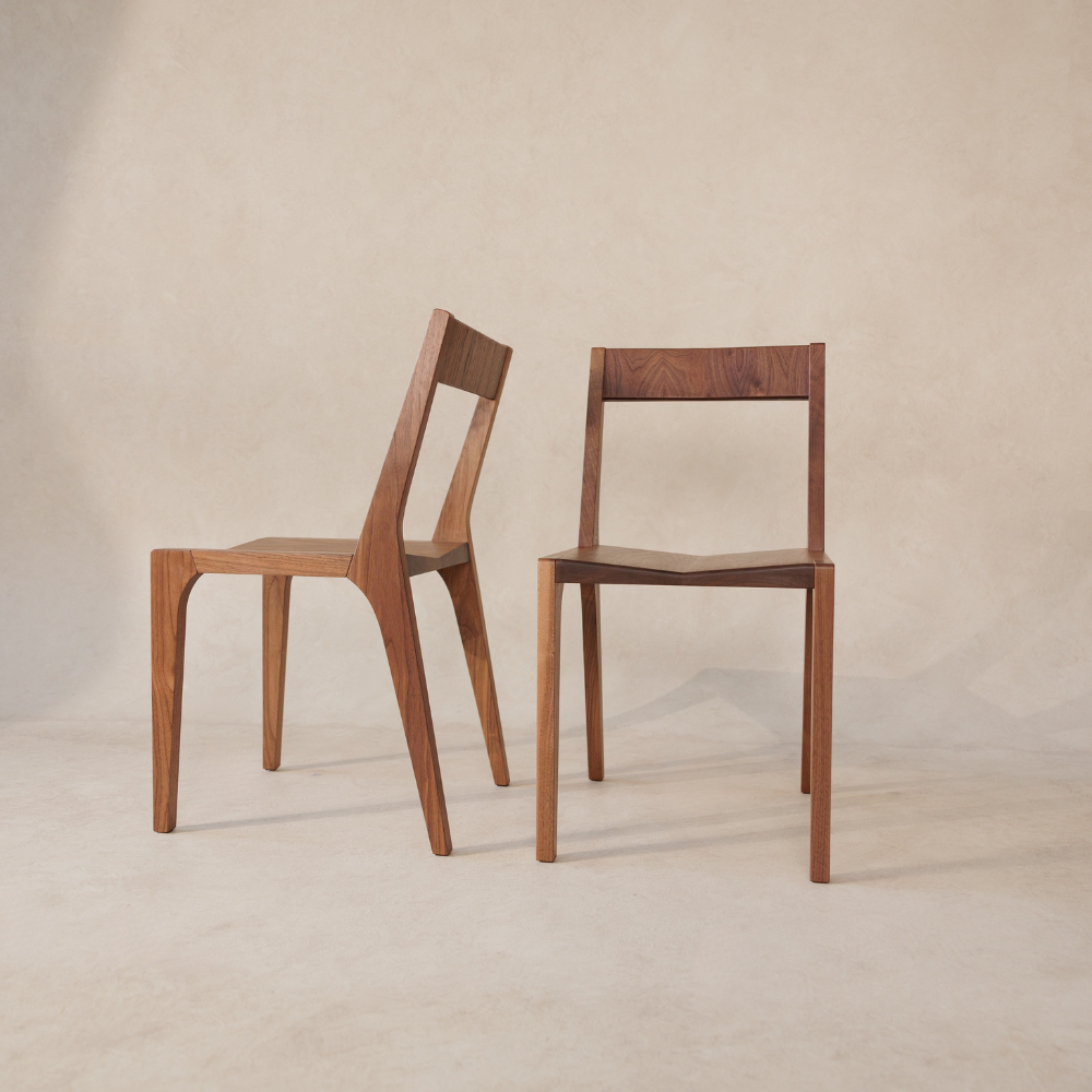 Two wooden chairs on a beige background