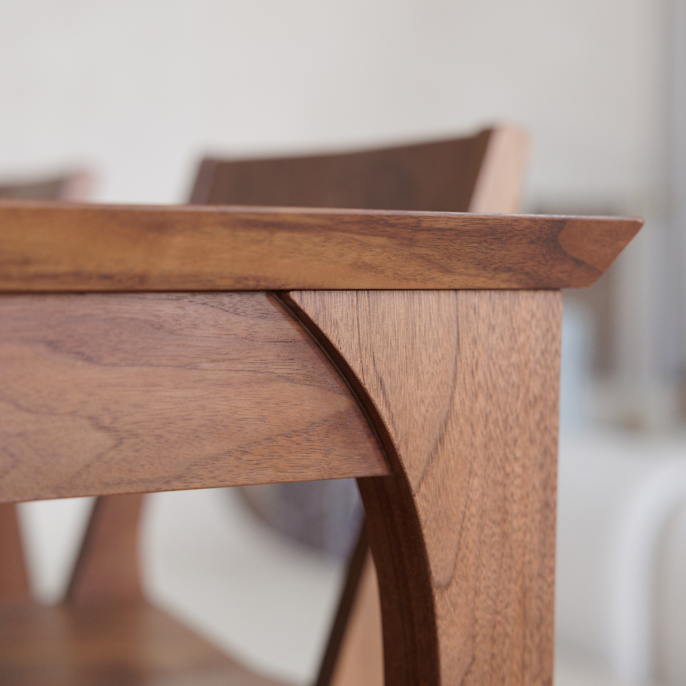 Close-up of a wooden table corner with a blurred background