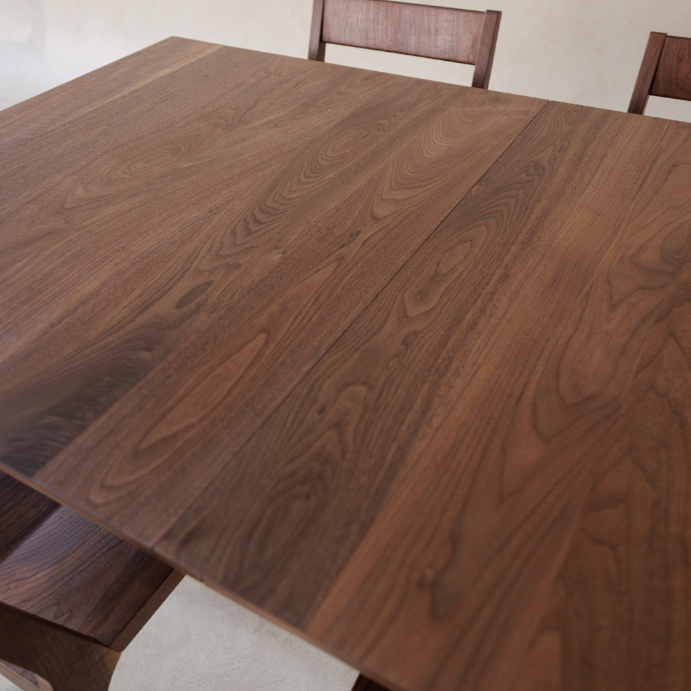 Wooden dining table with chairs in a room setting