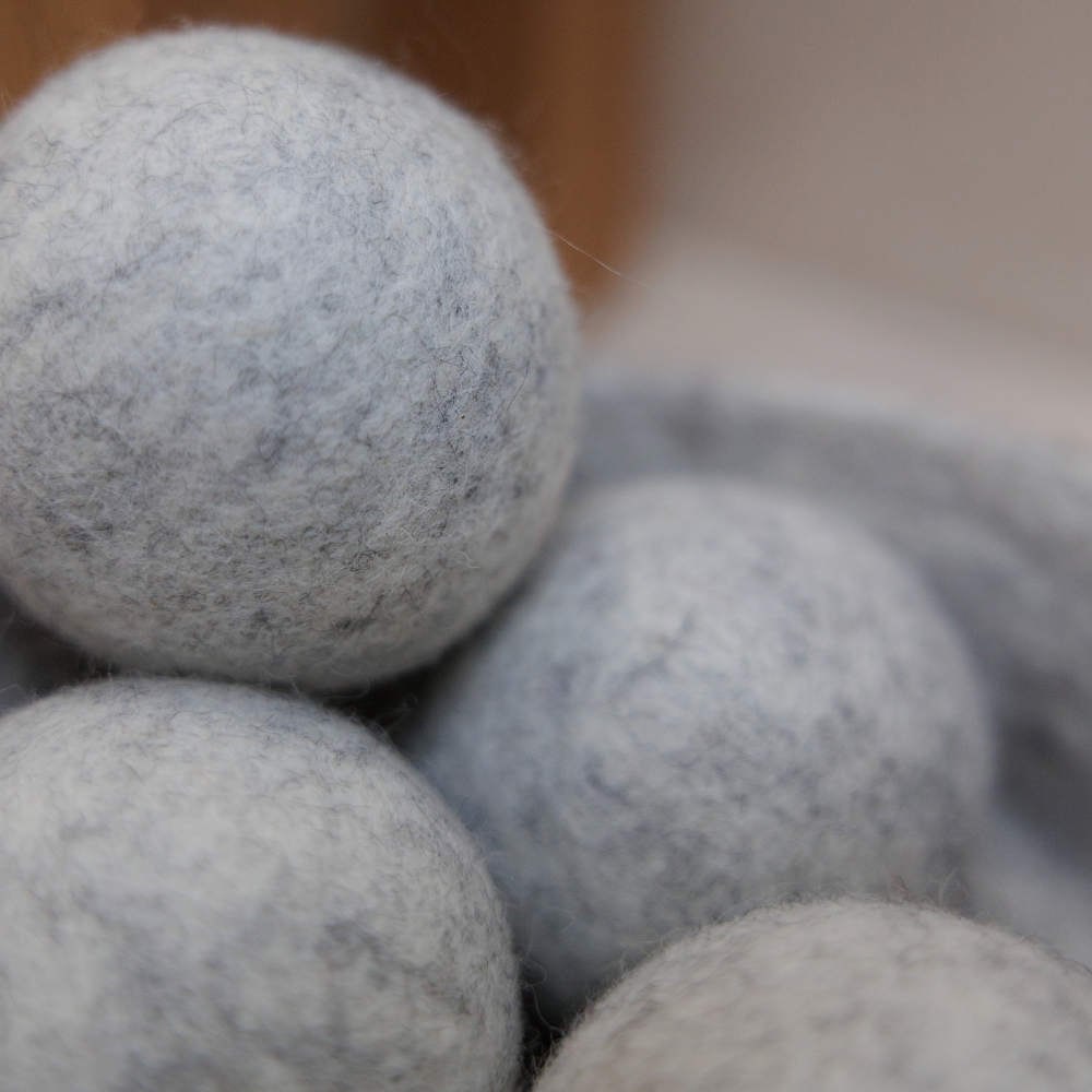 Close-up of grey dryer balls with a blurred background