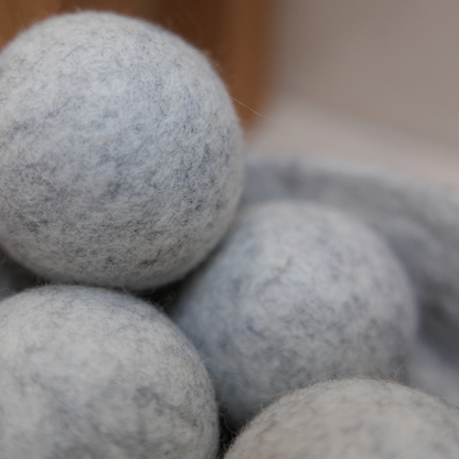 Close-up of grey dryer balls with a blurred background