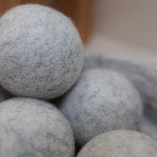 Close-up of grey dryer balls with a blurred background