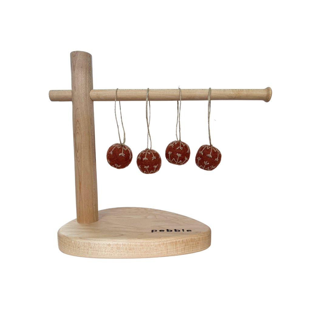 Rust colour felt baubles hanging from a wooden stand