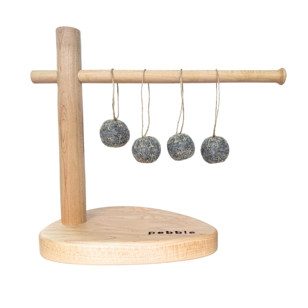 Four small felt snowflakes in Charcoal Marle with beige stitching, hanging from a wooden stand