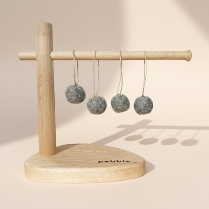 Four small felt snowflakes in Charcoal Marle with beige stitching, hanging from a wooden stand