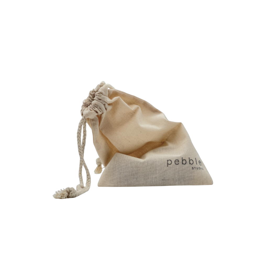 Beige drawstring bag with 'pebble studio' branding on a white background