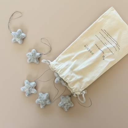 Star-shaped decorations with a drawstring bag on a beige background