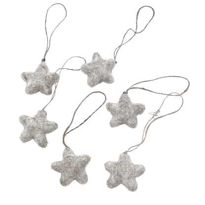 Six tiny felt star decorations on a light background