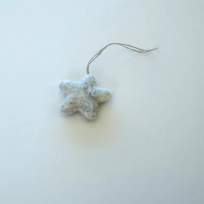 One tiny felt star decoration on a light background