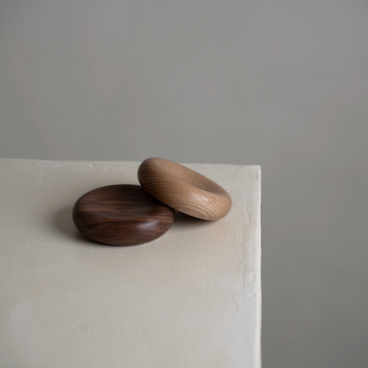 Two wood decorative pillows in small. The bowls are made from oak and walnut
