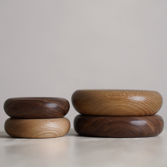 Four wood decorative pillows in small and medium sizes. The bowls are made from oak and walnut