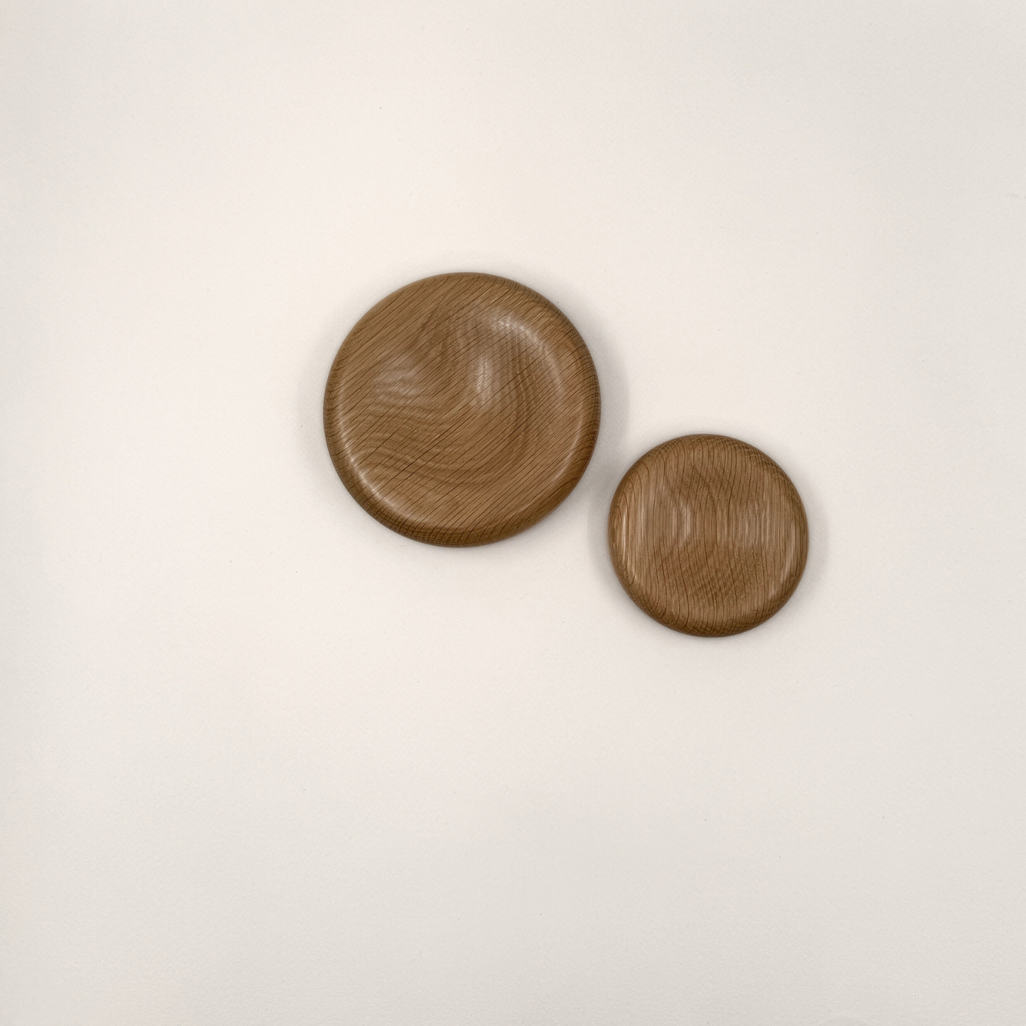 Two wood decorative pillows in small and medium sizes. The bowls are made from oak.