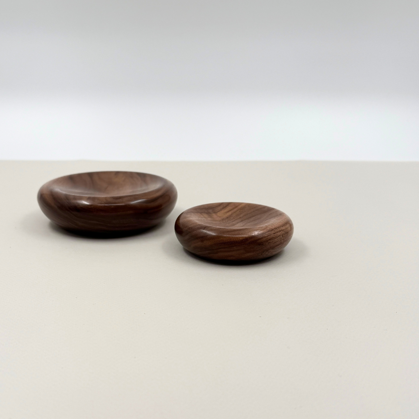Two wooden bowls on a light gray background