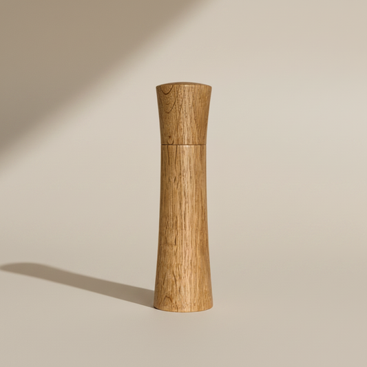 Large Pebble Studio Salt & Pepper Mill in American Oak. Minimalist design on aneutral background