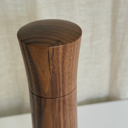 Minimalist curved top of a Pebble Studio handcrafted Walnut salt & pepper mill in Large size