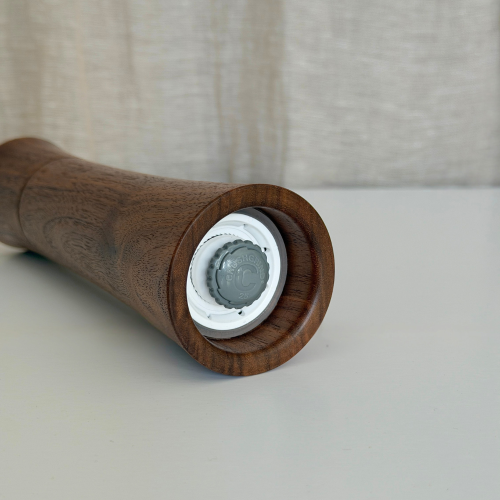 Pebble Studio handcrafted Walnut salt & pepper mill in Medium showing the Crushgrind Mechanism