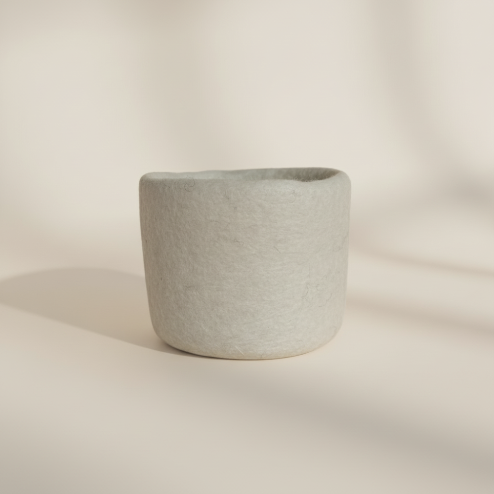 Loft Wool Felt Extra Small Basket  in Snow- natural white wool felt catchall basket on a light background