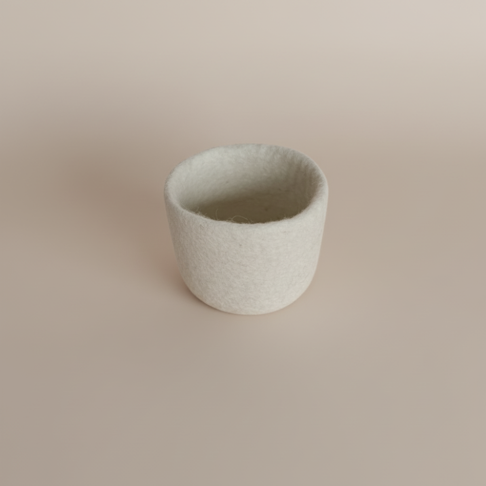 Loft Wool Felt Extra Small Basket  in Snow- natural white wool felt catchall basket on a light background