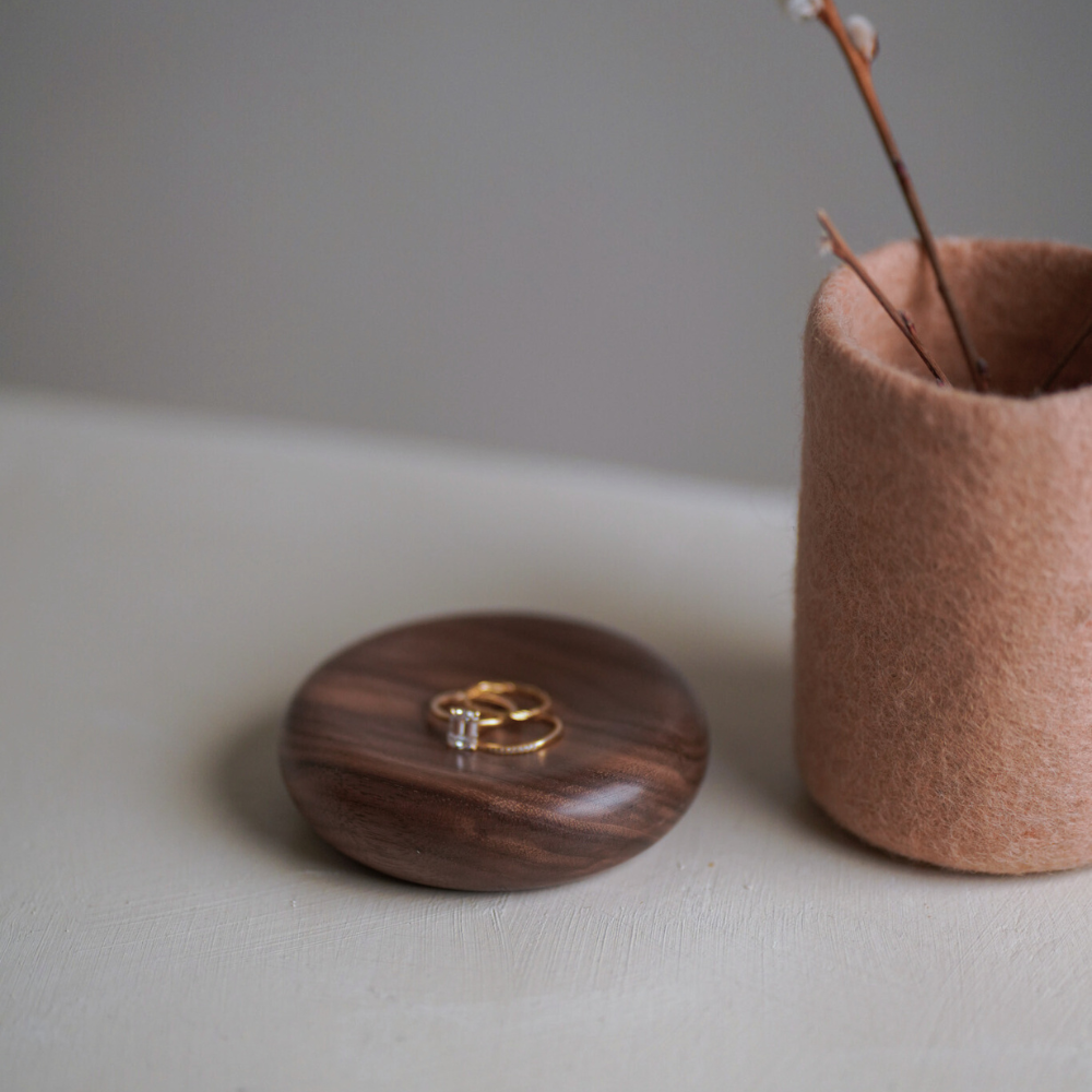 soft blush handcrafted vase styled next to a wood bowl with jewellery