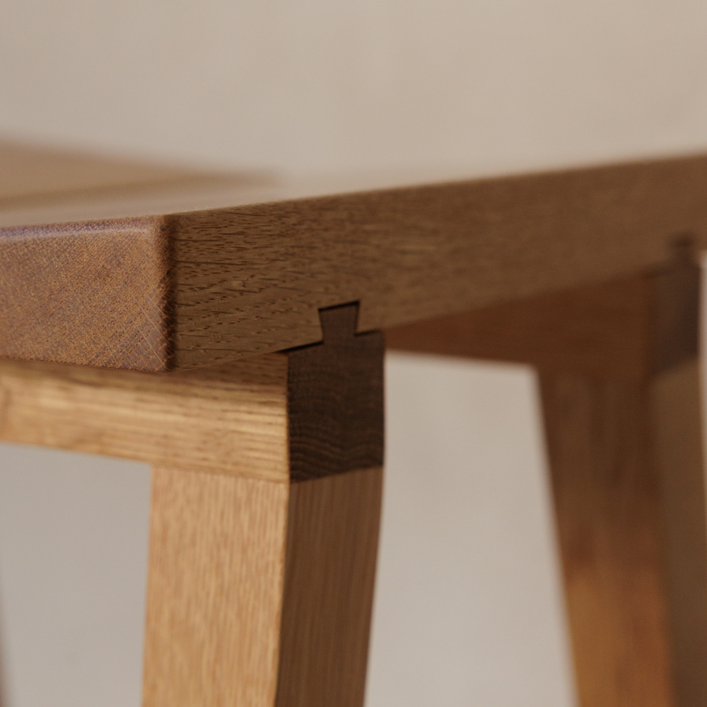 Close-up of a wooden stool corner with a visible joint.