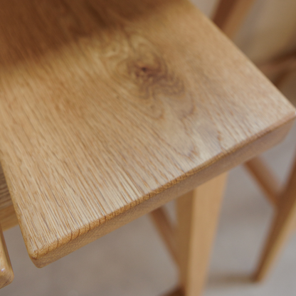 Close-up of a wooden chair seat with a blurred background