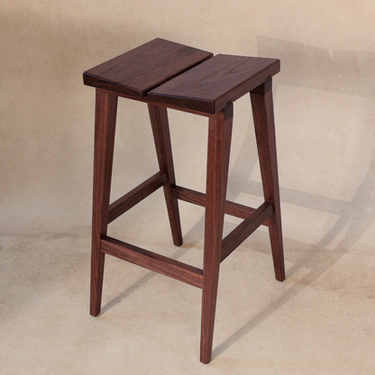 Wooden bar stool on a beige background