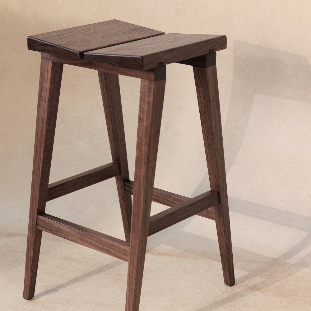 Wooden bar stool on a beige background