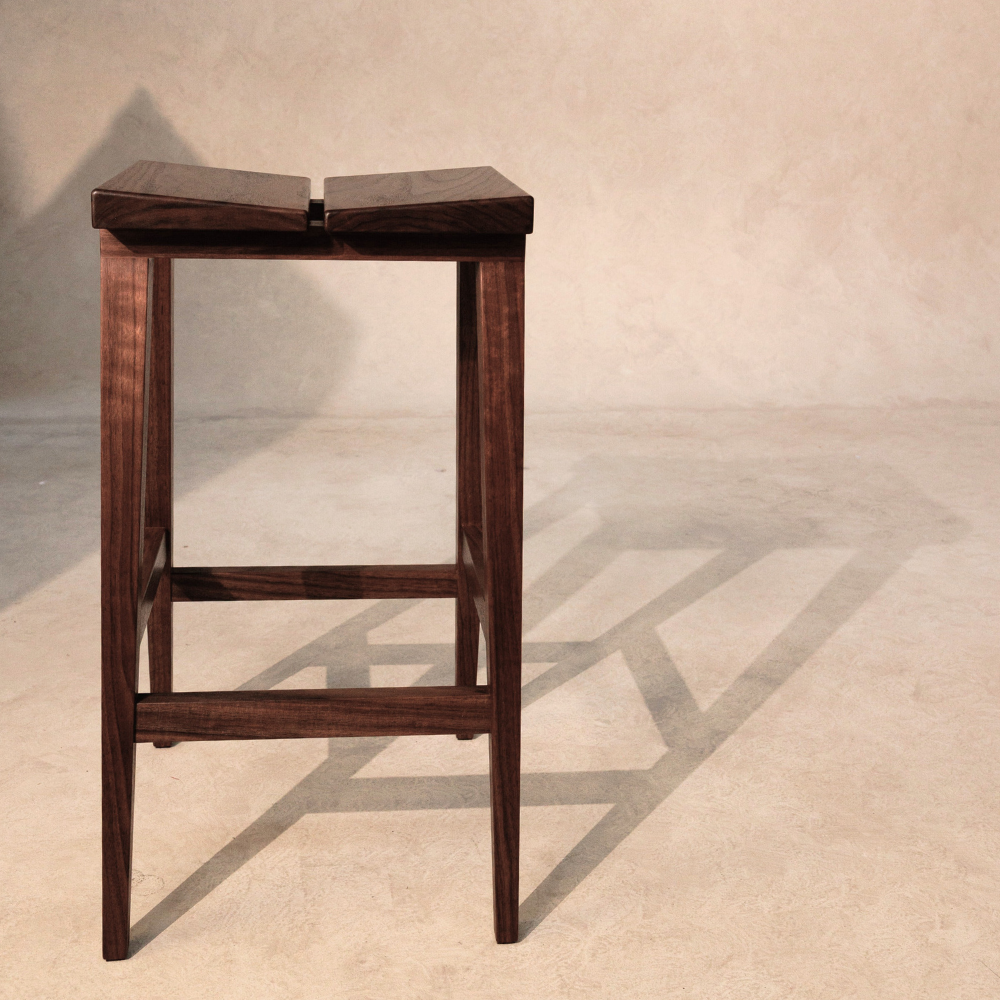 Wooden bar stool on a neutral background