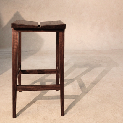 Wooden bar stool on a neutral background